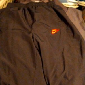 Nwot Men's Nike windbreaker pants with orange Nike logo and orange&red stripe